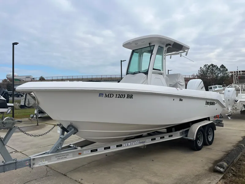 Slide: The Image of 2022 Everglades 235 Center Console boat on trailer, parked outdoors. - 3