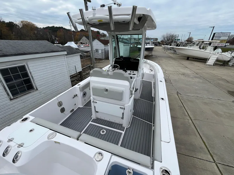 Slide: The Image of 2022 Everglades 235 Center Console boat on display at a marina. - 7