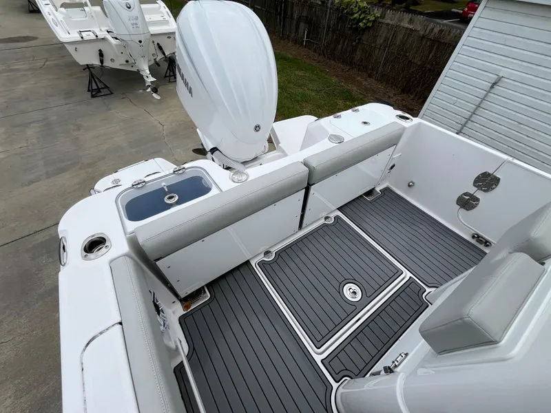 Slide: The Image of 2022 Everglades 235 Center Console boat interior with seating and motor. - 8