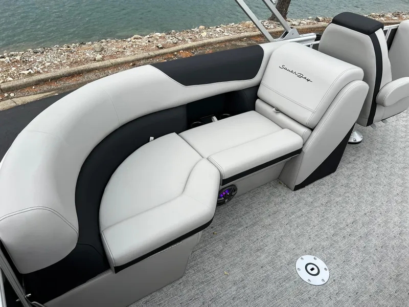 Slide: The Image of 2025 South Bay 222 RS LE boat interior with plush seating by the water. - 16