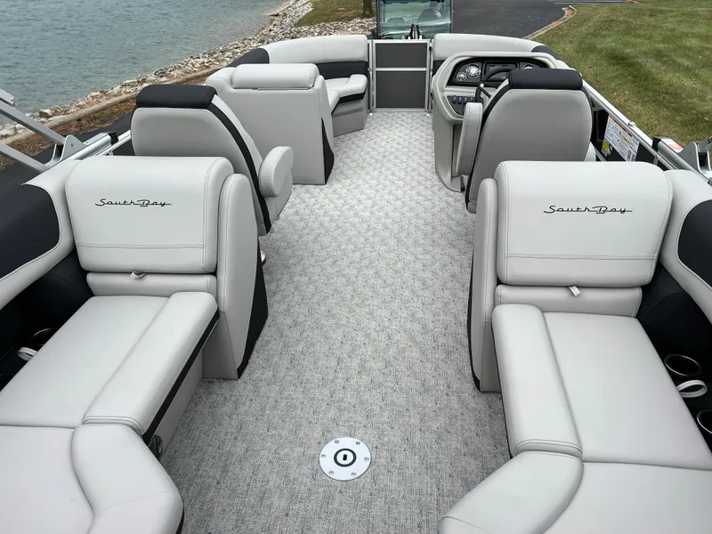 Slide: The Image of 2025 South Bay 222 RS LE pontoon boat interior with plush seating and modern design. - 17