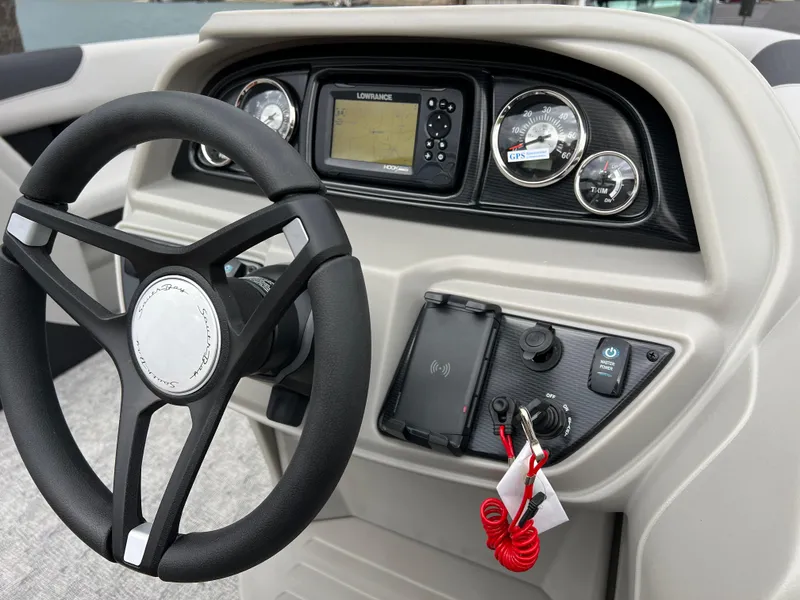 Slide: The Image of 2025 South Bay 222 RS LE boat dashboard with steering wheel and control panel. - 21