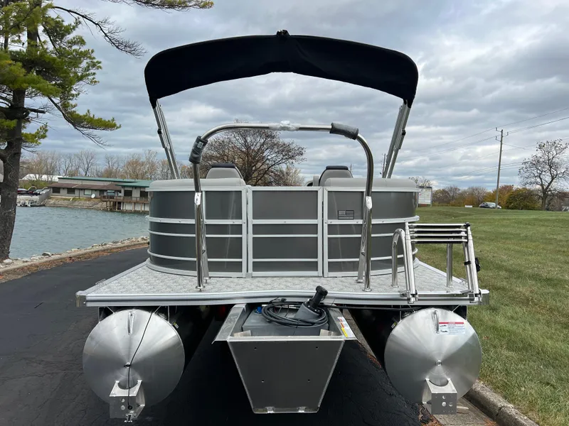 Slide: The Image of 2025 South Bay 222 RS LE pontoon boat on a lakeside road. - 6