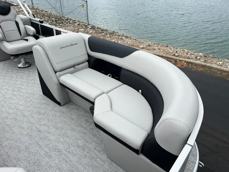 Slide: The Image of 2025 South Bay 222 RS LE pontoon boat with luxurious seating by the water. - 9