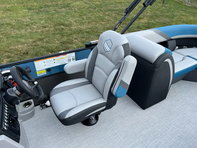 Slide: The Image of 2025 South Bay SS222 RS boat interior with plush captain's chair and modern dashboard. - 14