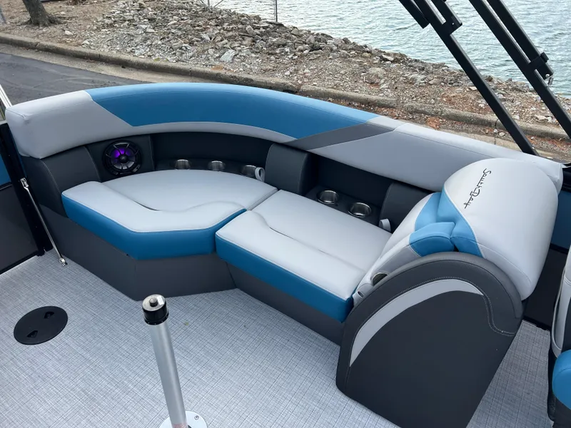 Slide: The Image of 2025 South Bay SS222 RS boat interior with blue and gray seating by the water. - 17