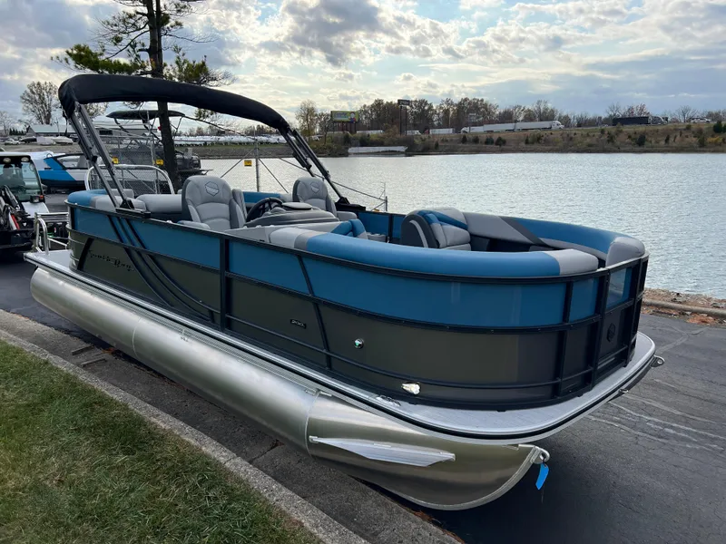 Slide: The Image of 2025 South Bay SS222 RS pontoon boat docked by a scenic lake. - 4