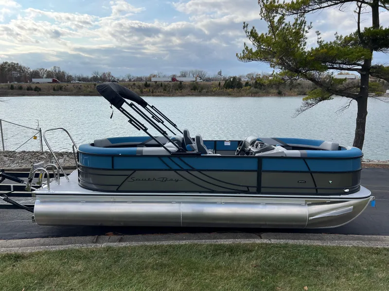 Slide: The Image of 2025 South Bay SS222 RS pontoon boat by a serene lake. - 5
