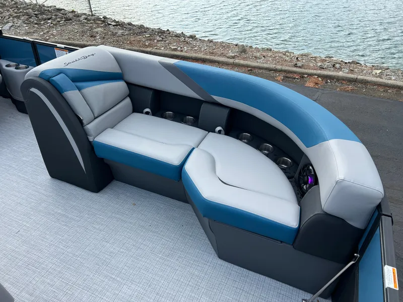 Slide: The Image of 2025 South Bay SS222 RS boat seating with blue and gray upholstery by the water. - 8
