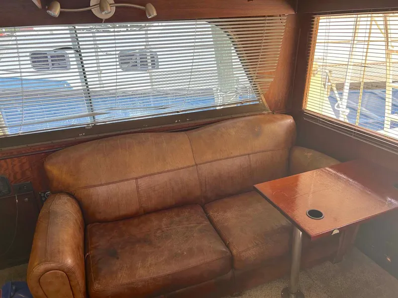 Slide: The Image of Interior of 1975 Hatteras 36 Convertible with leather sofa and wooden table. - 13