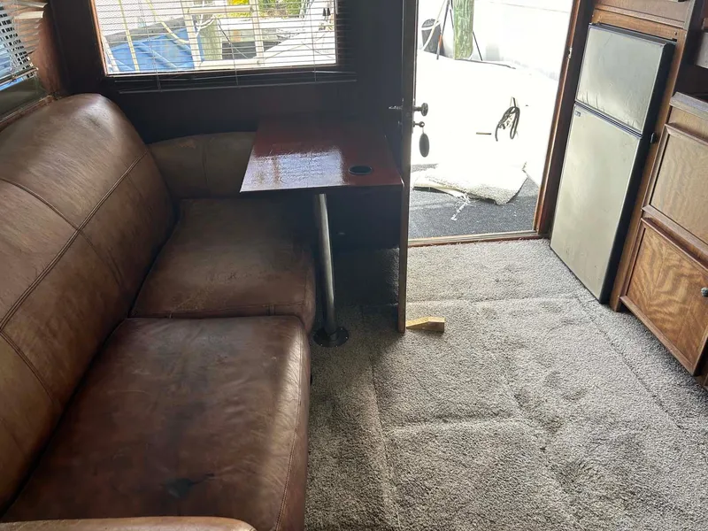 Slide: The Image of Interior of 1975 Hatteras 36 Convertible with leather sofa and carpeted floor. - 14