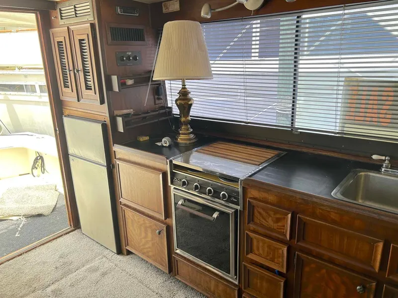 Slide: The Image of Interior of a 1975 Hatteras 36 Convertible yacht with kitchen amenities. - 15