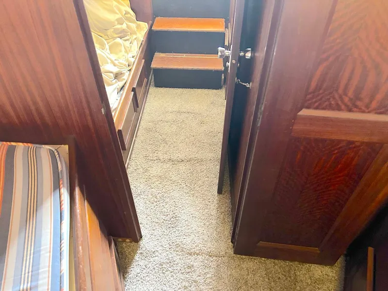 Slide: The Image of Interior of 1975 Hatteras 36 Convertible with carpeted hallway and wooden doors. - 27