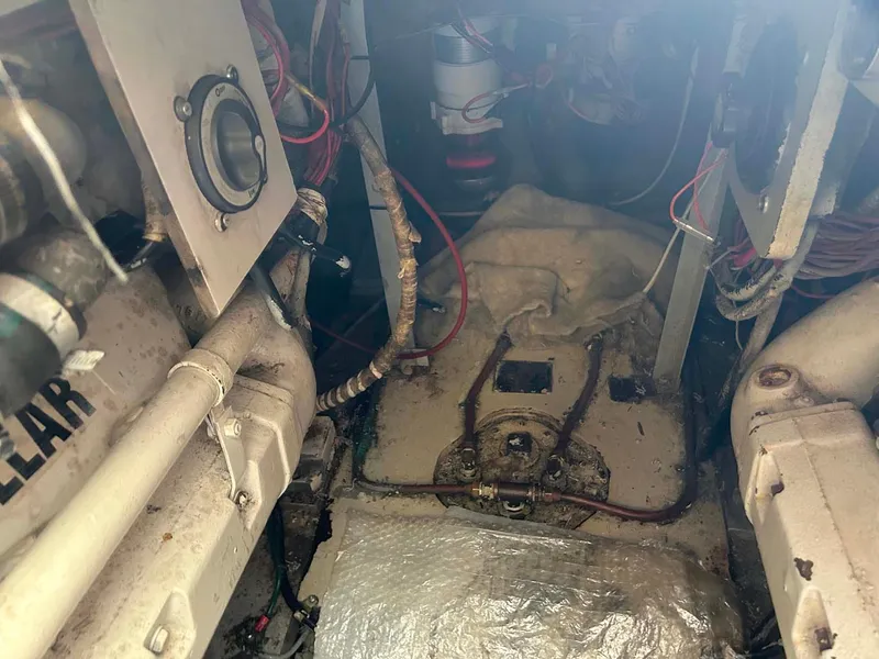 Slide: The Image of Engine room of 1975 Hatteras 36 Convertible boat, showing mechanical components and wiring. - 29