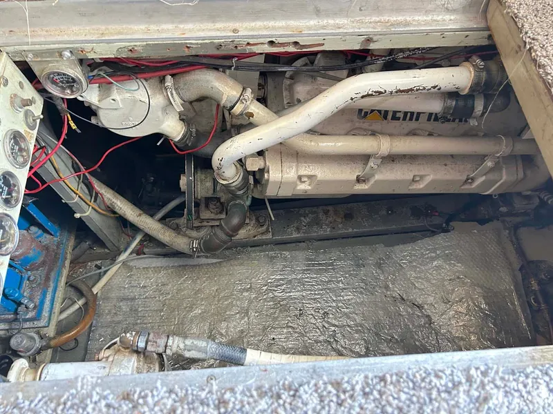 Slide: The Image of Engine compartment of a 1975 Hatteras 36 Convertible boat, showing mechanical components and wiring. - 30
