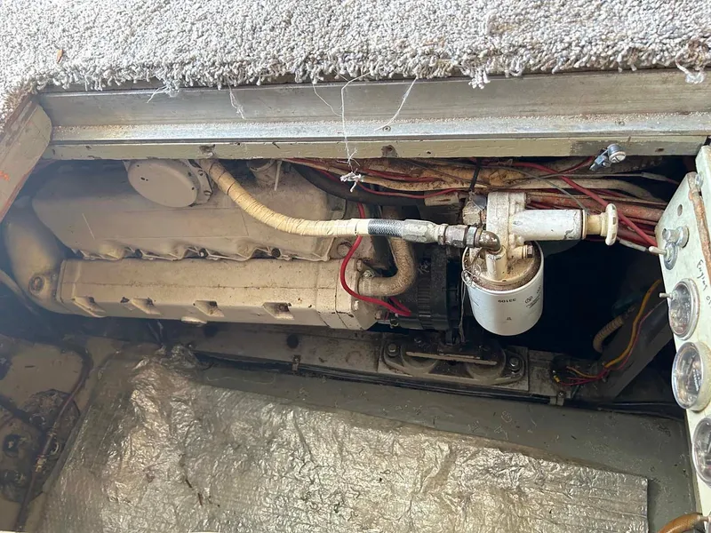 Slide: The Image of Engine compartment of a 1975 Hatteras 36 Convertible boat, showing mechanical components. - 31