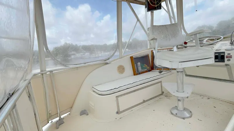 Slide: The Image of 1975 Hatteras 36 Convertible boat interior with seating and helm, featuring panoramic windows. - 35