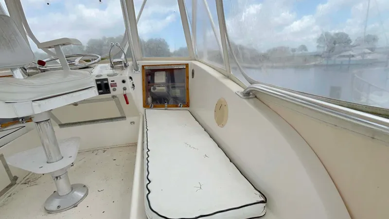 Slide: The Image of 1975 Hatteras 36 Convertible boat interior with helm and seating area. - 36