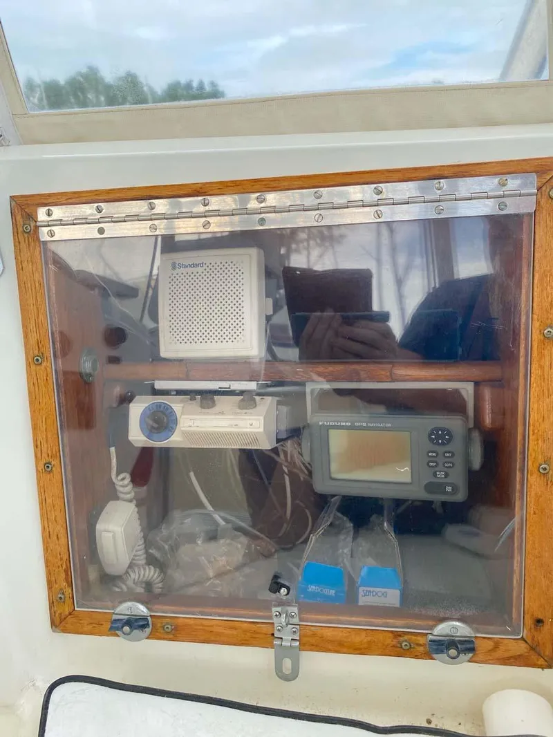 Slide: The Image of 1975 Hatteras 36 Convertible boat dashboard with navigation and communication equipment. - 37