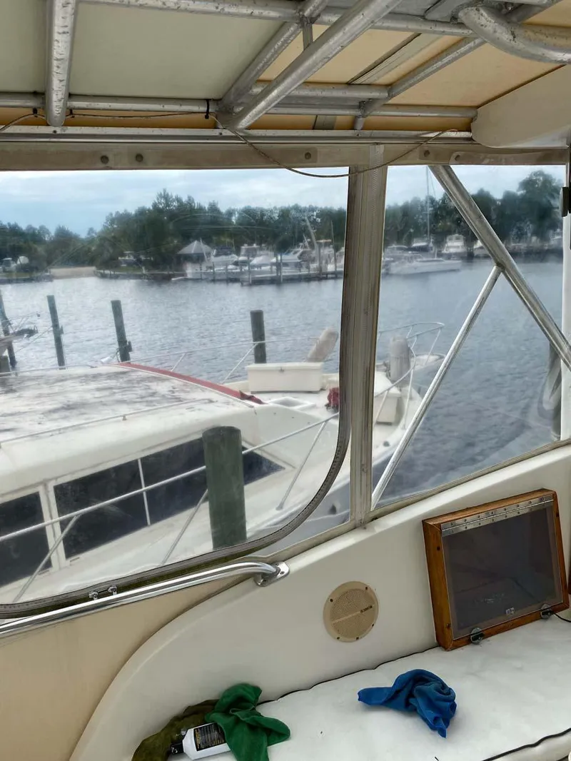 Slide: The Image of 1975 Hatteras 36 Convertible yacht docked at a marina, view from interior cabin. - 38