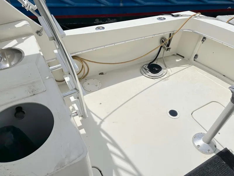 Slide: The Image of 1975 Hatteras 36 Convertible boat deck with fishing rod holders and storage compartments. - 4