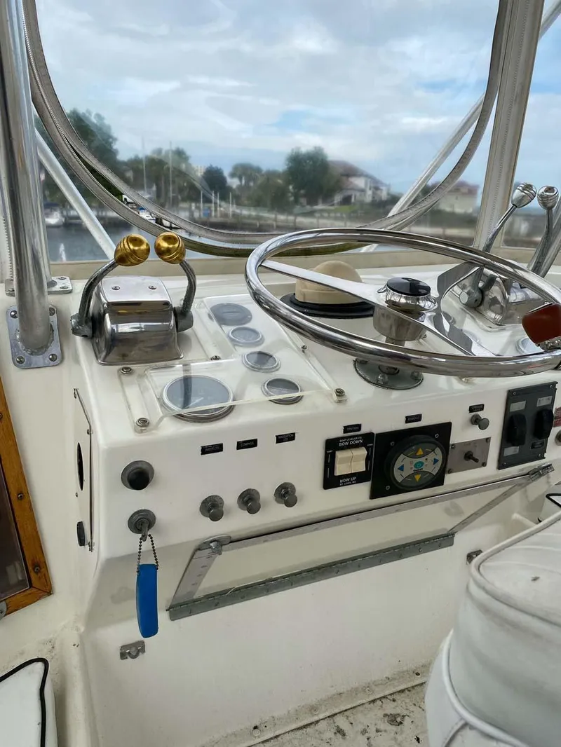 Slide: The Image of 1975 Hatteras 36 Convertible boat helm with steering wheel and control panel. - 44