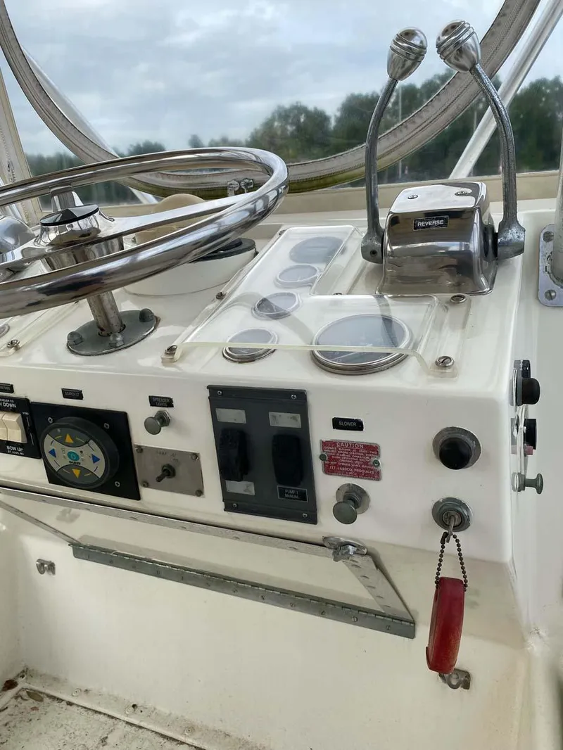 Slide: The Image of 1975 Hatteras 36 Convertible helm with steering wheel and control panel. - 45