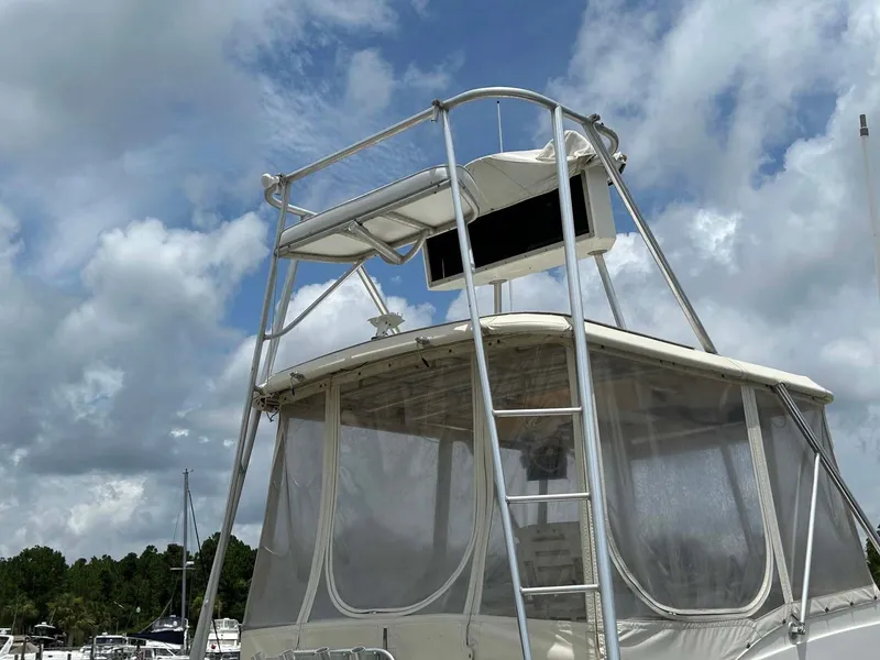 Slide: The Image of 1975 Hatteras 36 Convertible boat with flybridge under cloudy sky. - 48