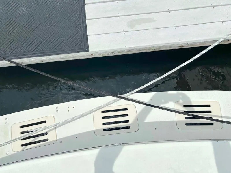 Slide: The Image of 1975 Hatteras 36 Convertible boat docked with ropes and shadow on deck. - 8