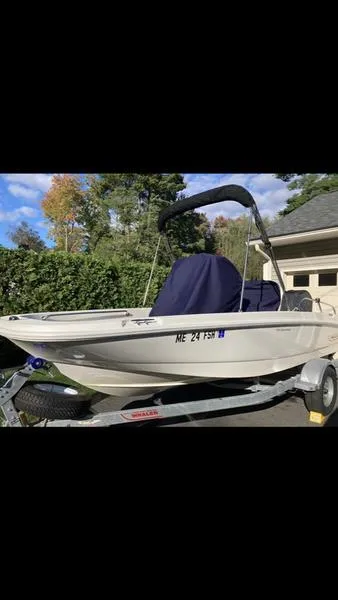Slide: The Image of 2018 Boston Whaler 170 Dauntless boat on trailer, parked outdoors. - 4