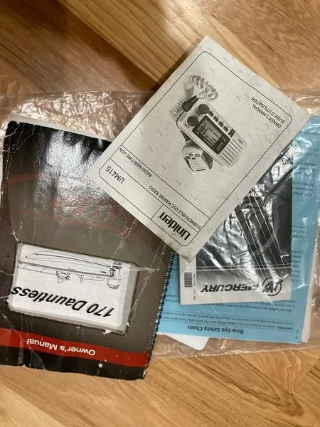 Slide: The Image of Boston Whaler 170 Dauntless 2018 manuals and safety guides on wooden surface. - 5