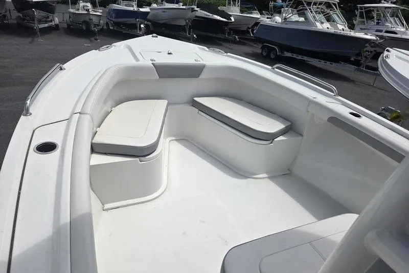 Slide: The Image of 2025 Parker 23 SE CC boat interior with cushioned seating and sleek design. - 13