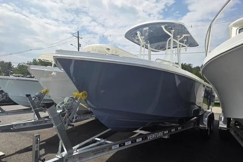 Slide: The Image of 2025 Parker 23 SE CC boat on trailer under cloudy sky. - 3