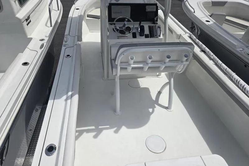 Slide: The Image of 2025 Parker 23 SE CC boat interior with steering console and seating. - 6