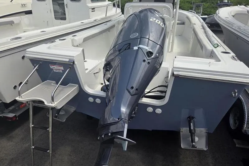 Slide: The Image of 2025 Parker 23 SE CC boat with powerful outboard motor and swim ladder. - 8