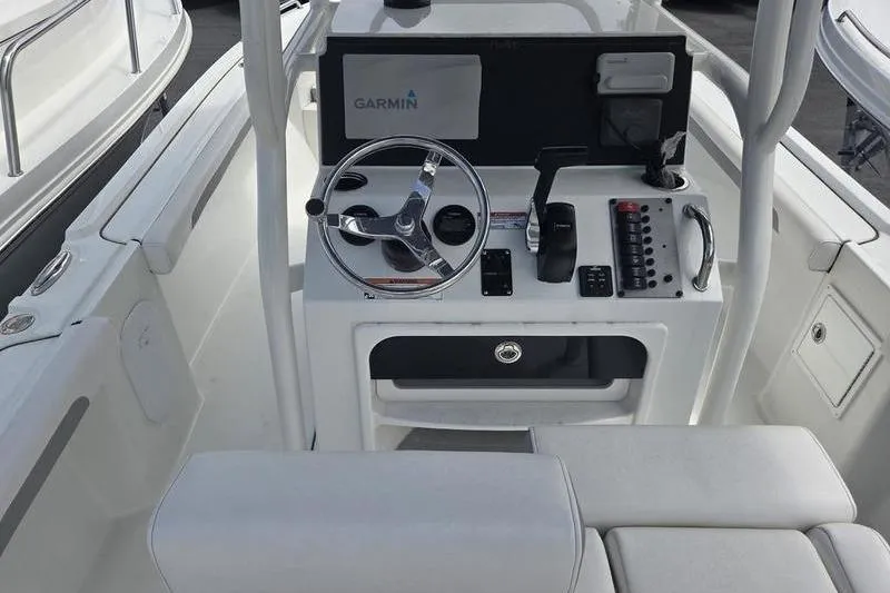 Slide: The Image of 2025 Parker 23 SE CC boat console with Garmin navigation system and steering wheel. - 9
