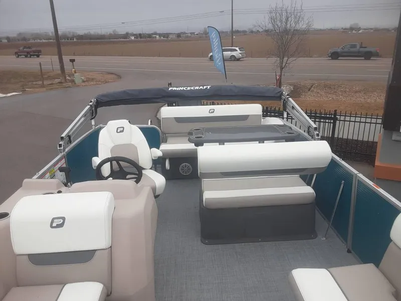 Slide: The Image of 2024 Princecraft Vectra 21 RL pontoon boat interior with seating and steering wheel. - 4