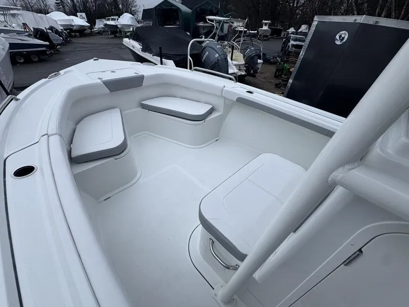 Slide: The Image of 2025 Parker 23 SE CC boat interior with white seating and storage compartments. - 11