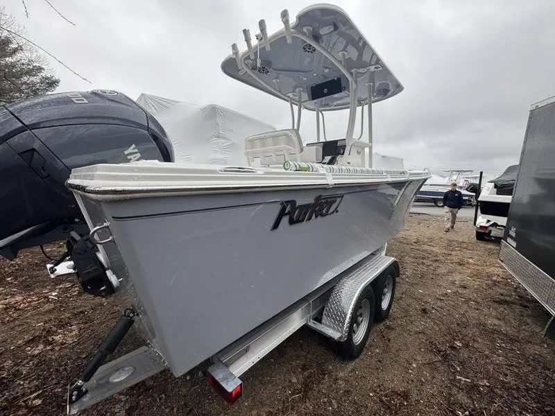 Slide: The Image of 2025 Parker 23 SE CC boat on trailer, displayed outdoors on a cloudy day. - 4