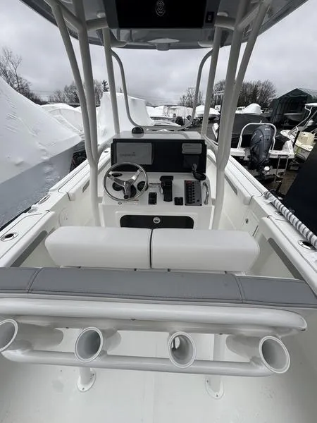 Slide: The Image of 2025 Parker 23 SE CC boat interior with steering console and rod holders. - 6