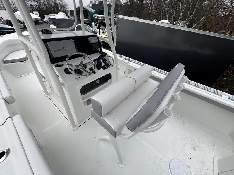 Slide: The Image of 2025 Parker 23 SE CC boat interior with steering console and seating. - 9