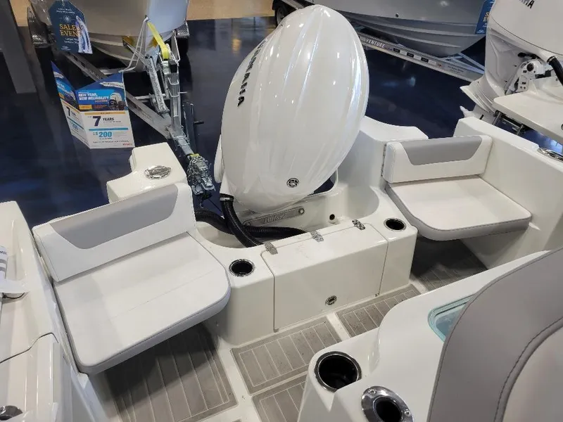 Slide: The Image of 2025 Parker 2200 CC boat interior with seating and outboard motor. - 10