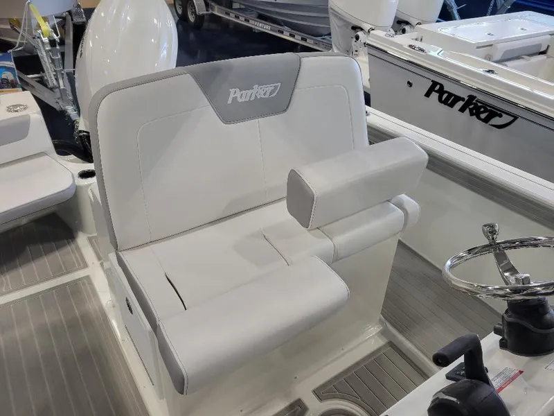 Slide: The Image of 2025 Parker 2200 CC boat interior with cushioned seating and steering wheel. - 11