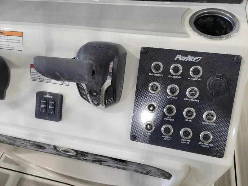 Slide: The Image of Control panel of 2025 Parker 2200 CC boat with switches and throttle. - 14