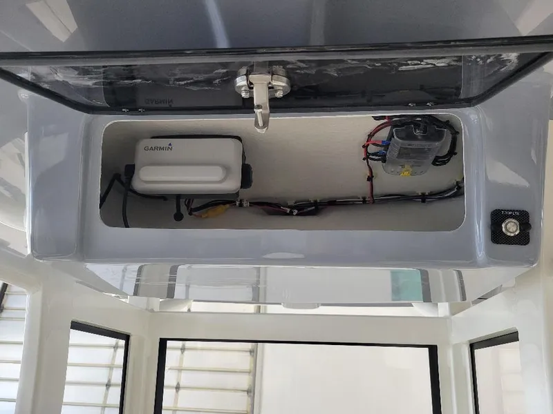 Slide: The Image of 2025 Parker 2200 CC boat electronics compartment with Garmin device and wiring. - 15
