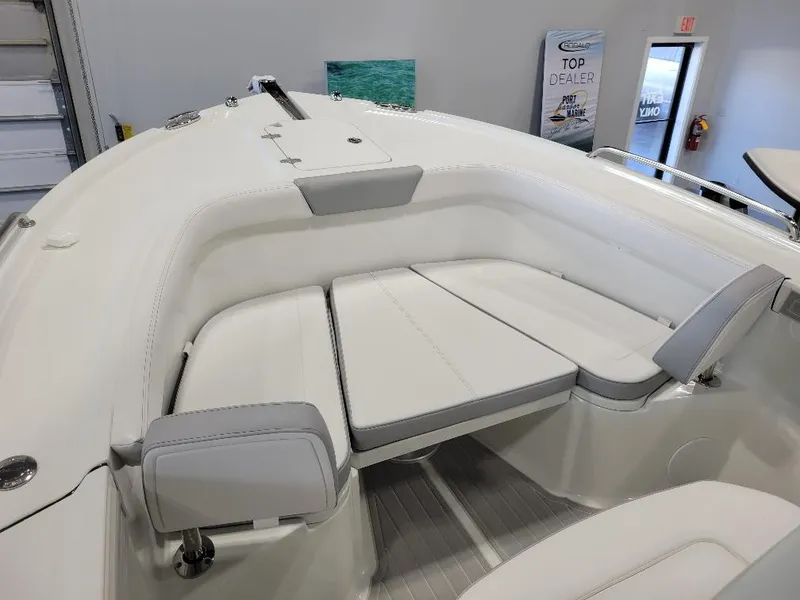 Slide: The Image of 2025 Parker 2200 CC boat interior with white cushioned seating. - 16