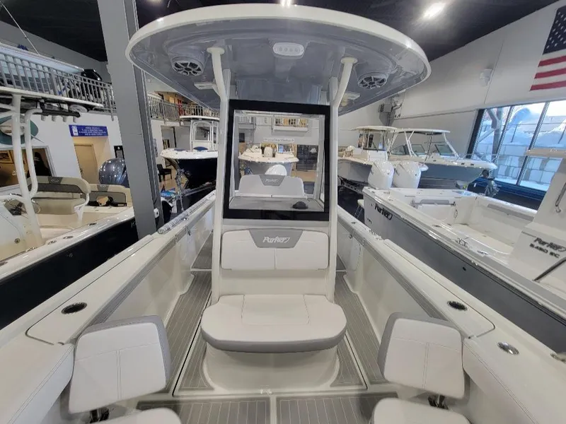 Slide: The Image of 2025 Parker 2200 CC boat interior in showroom, featuring seating and modern design. - 17