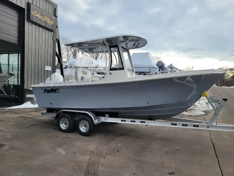 Slide: The Image of 2025 Parker 2200 CC boat on trailer outside Sea Ray dealership. - 2