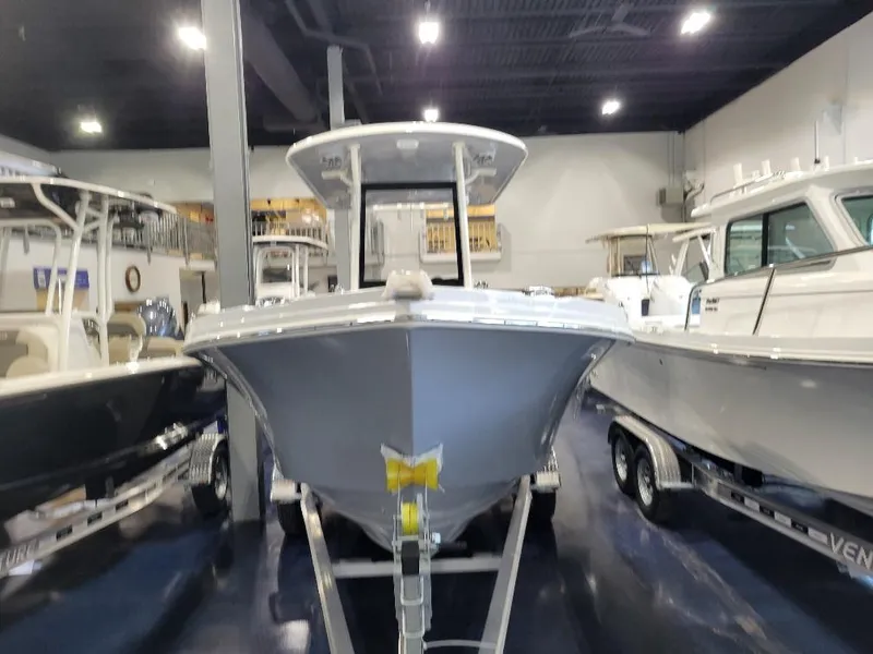 Slide: The Image of 2025 Parker 2200 CC boat displayed in showroom, front view. - 3