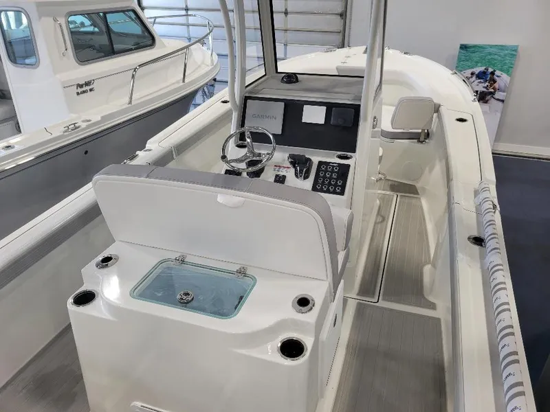 Slide: The Image of 2025 Parker 2200 CC boat interior with modern console and seating. - 9